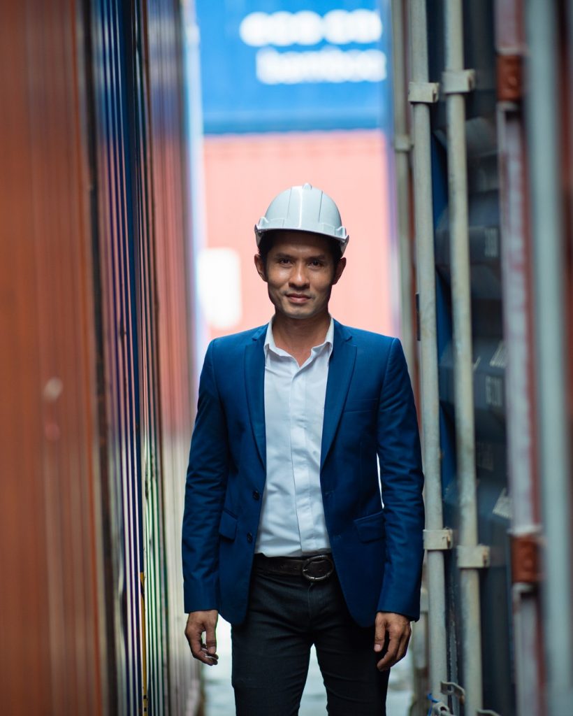 Portrait of foreman worker standing at Container cargo harbor to loading containers